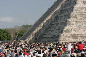 Crowds gather at El Castillo to witness the equinox light and shadow effect.