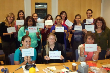group of females holding up cards with single words