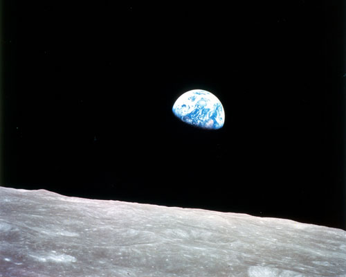 Earth rising over the lunar surface as seen by the Apollo 8 mission.