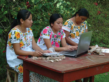 Maya women at San Simon enter GIS data into a computer to tag pottery sherds. Image Credit: Jose Huchim Herrera, INAH