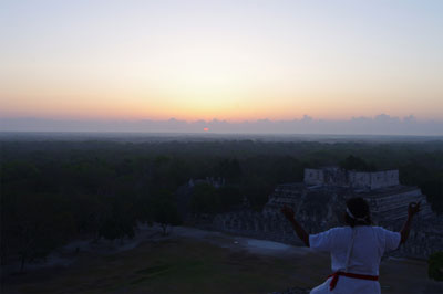 Image shows Maya Priest Tiburcio Can May greeting the rising Sun on the day of zenith passage at Chichen Itza, Mexico.
