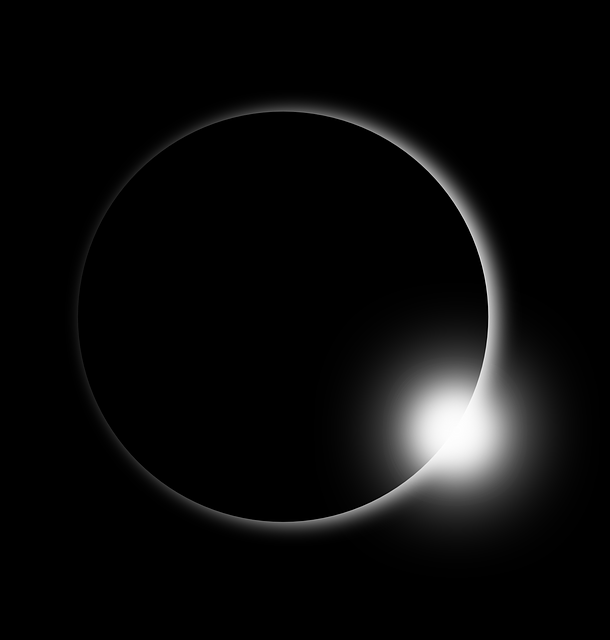 white ring of sun's corona against black space