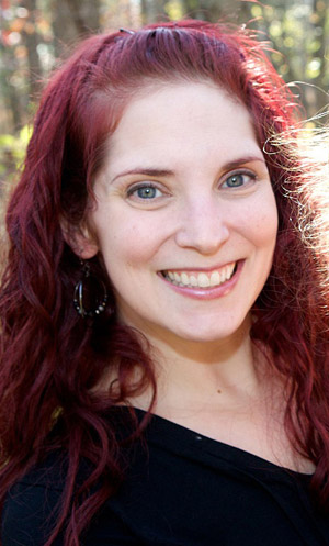 smiling woman with magenta hair